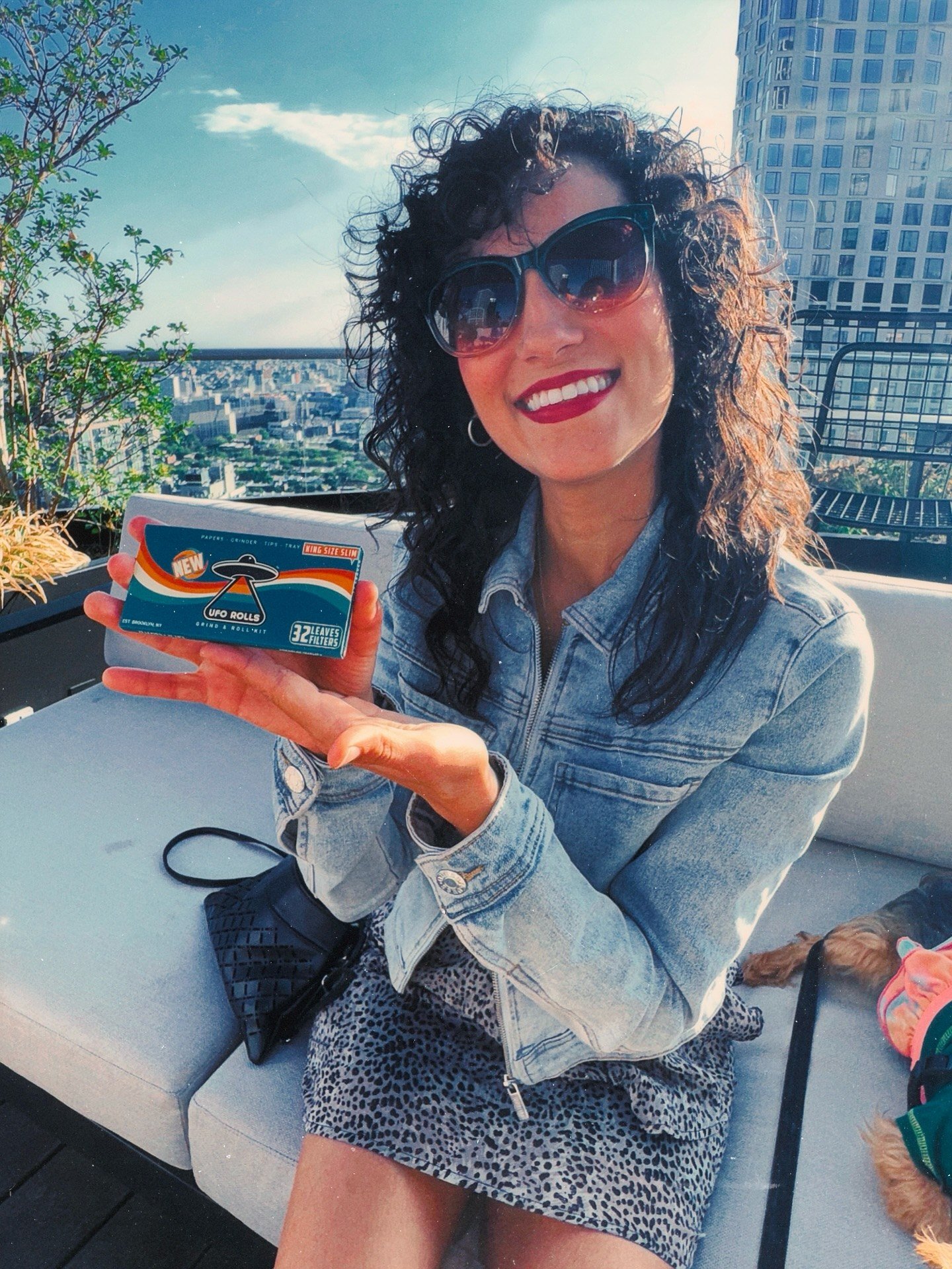 A partner presenting UFO ROLLS papers at a rooftop activation